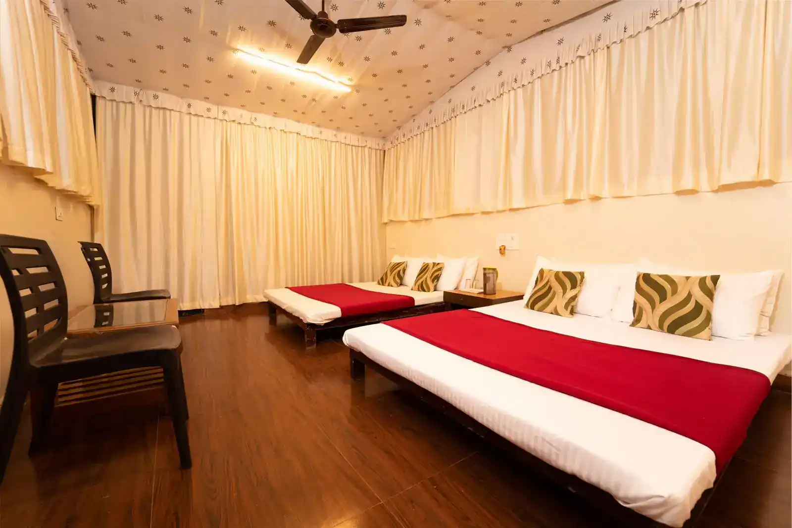 Commando cottage interior with multiple beds for group stay at Wild Wings Dandeli